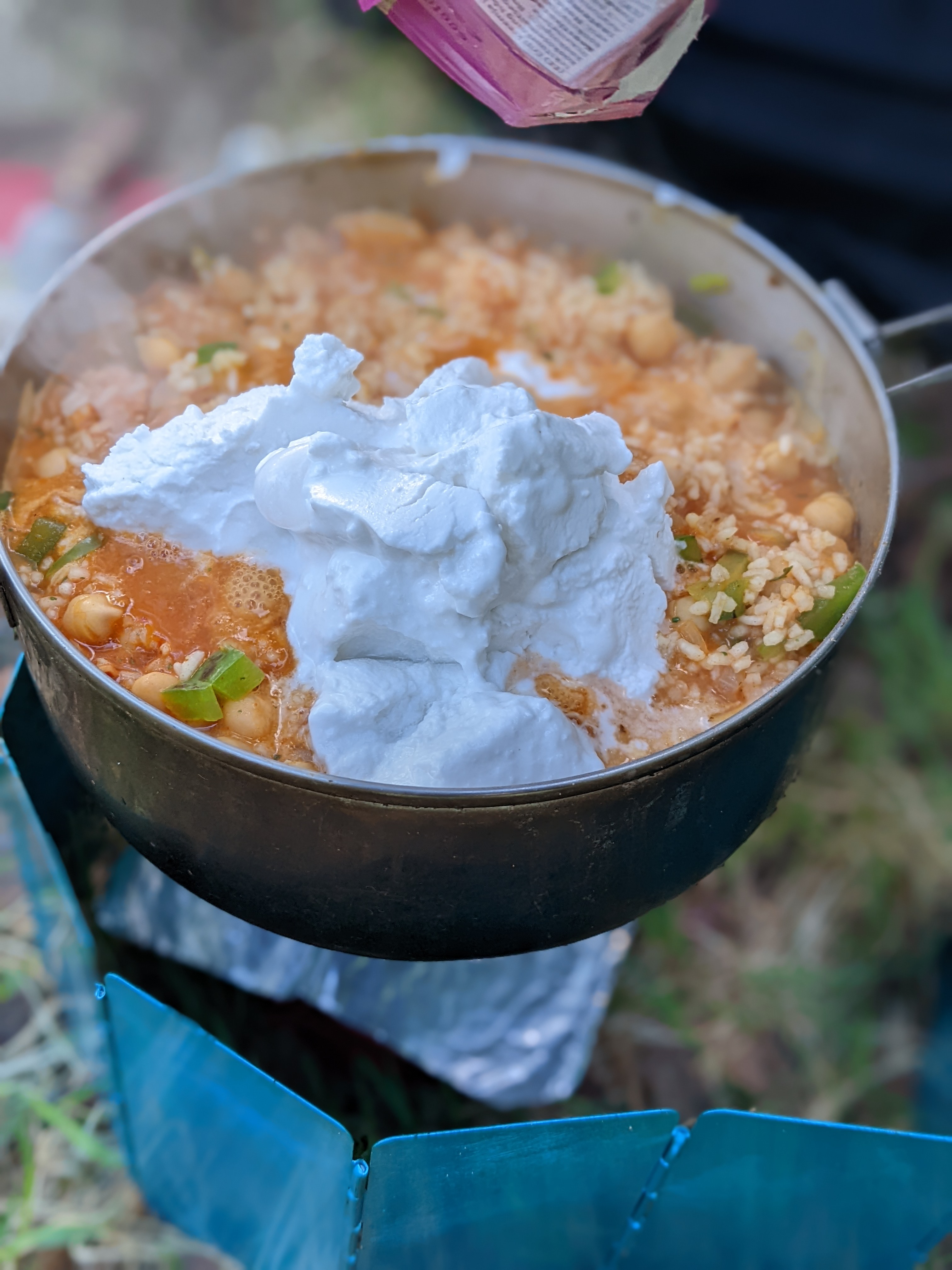 a huge blob of coconut cream on top of a steaming pot of food
