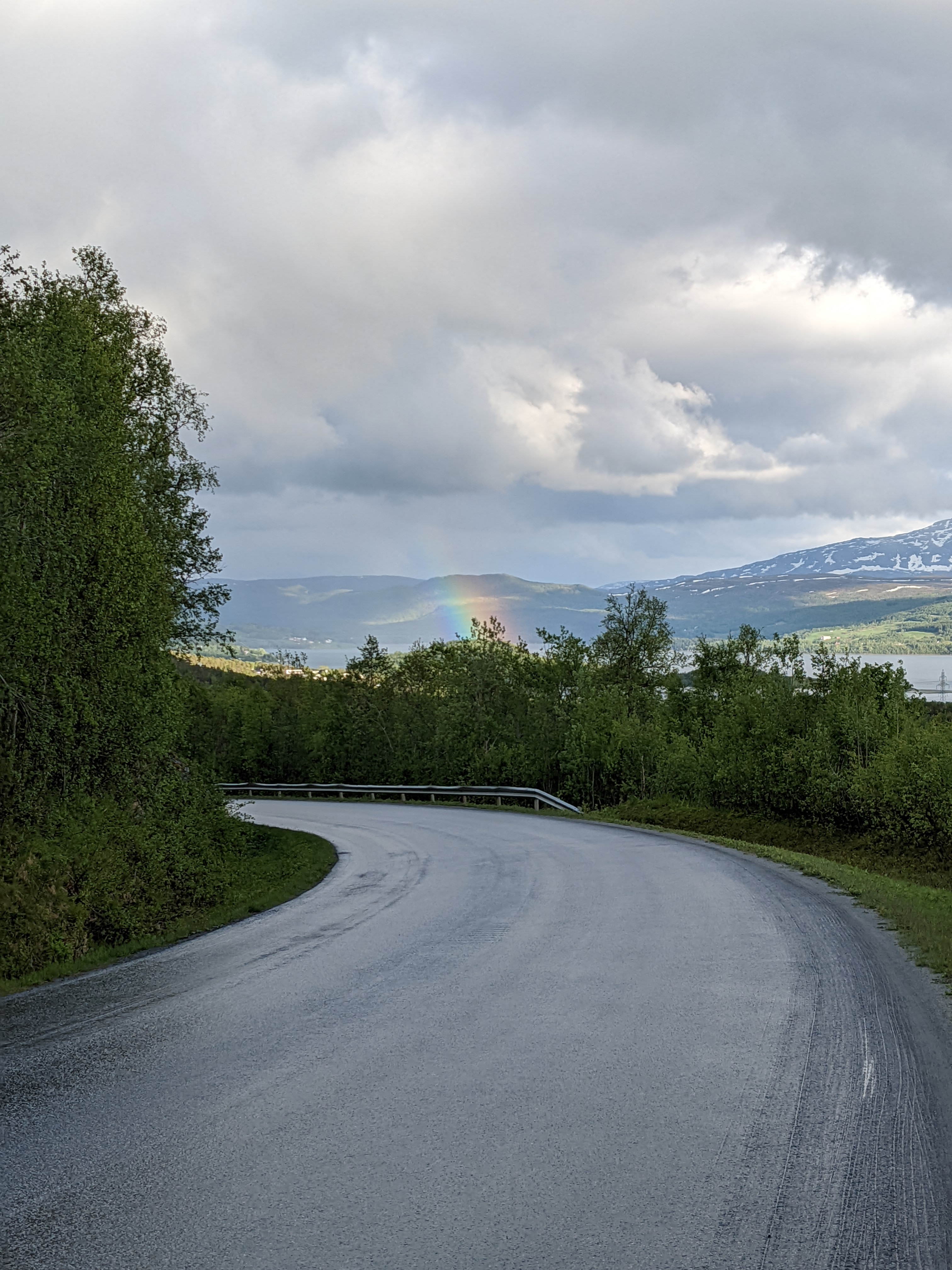 a rainbow over the fjord at the end of the day's last pass