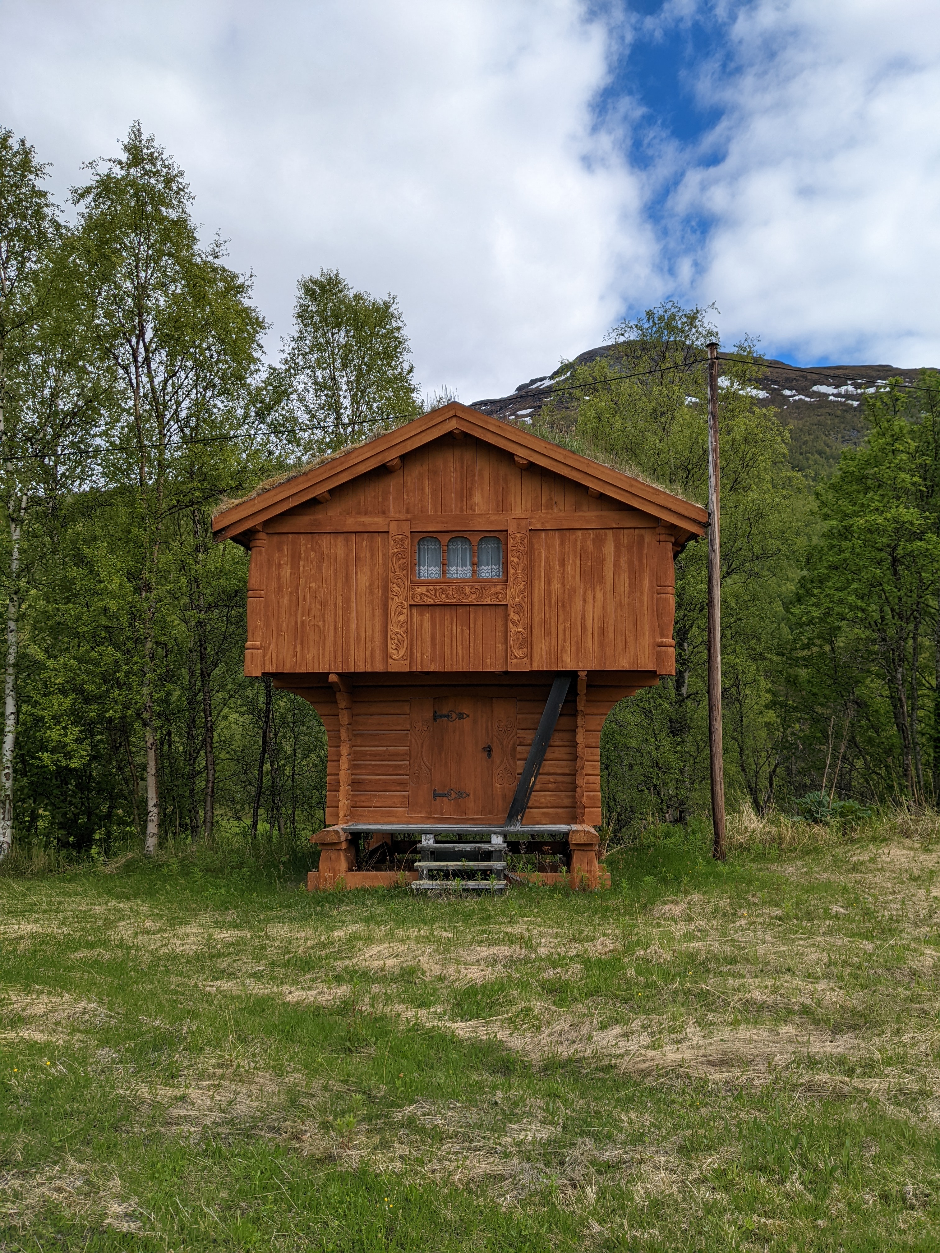 a traditional cabin with a normal house-shaped second story sitting on top of a narrower first story