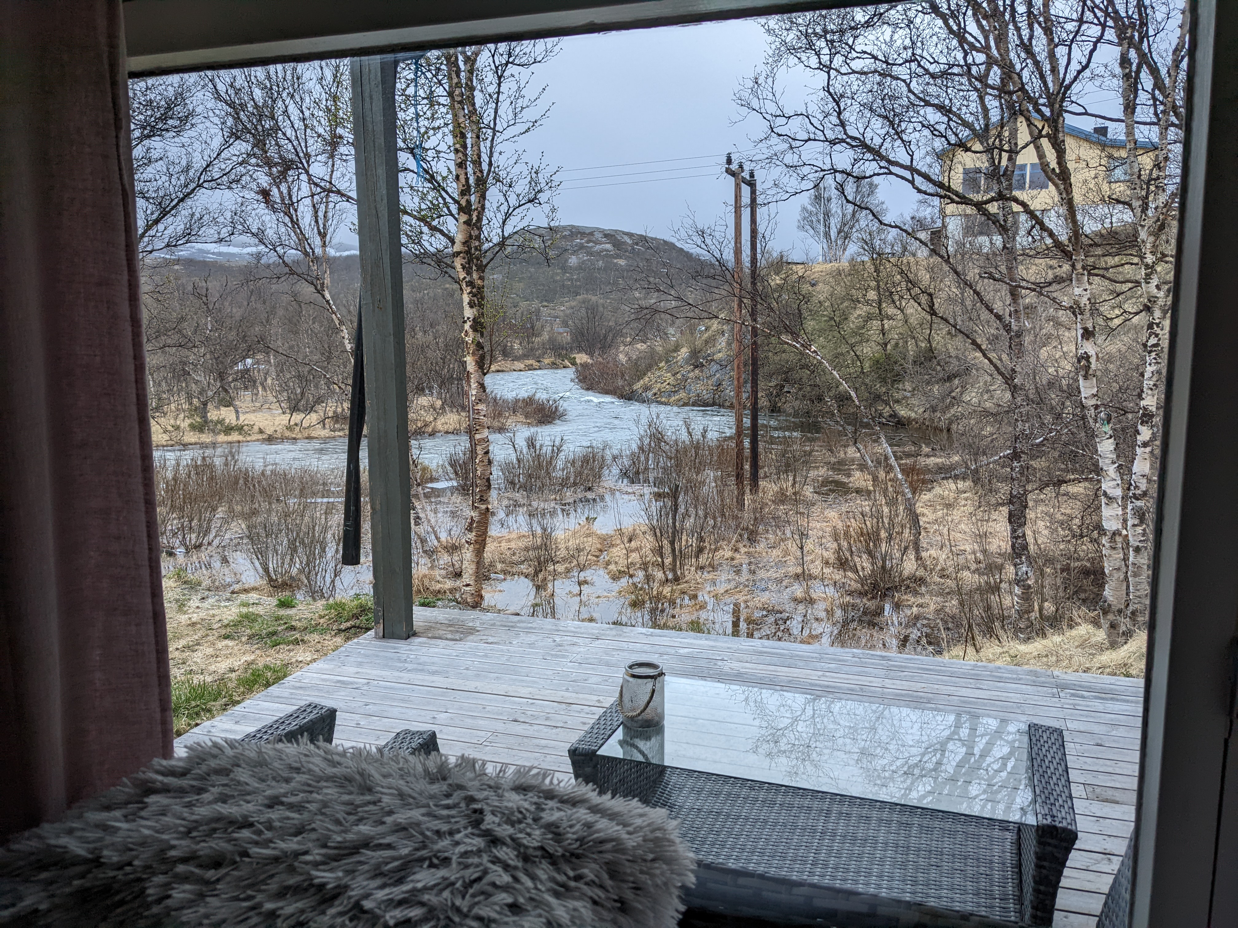 a view of the river in flood from the back porch of our cabin