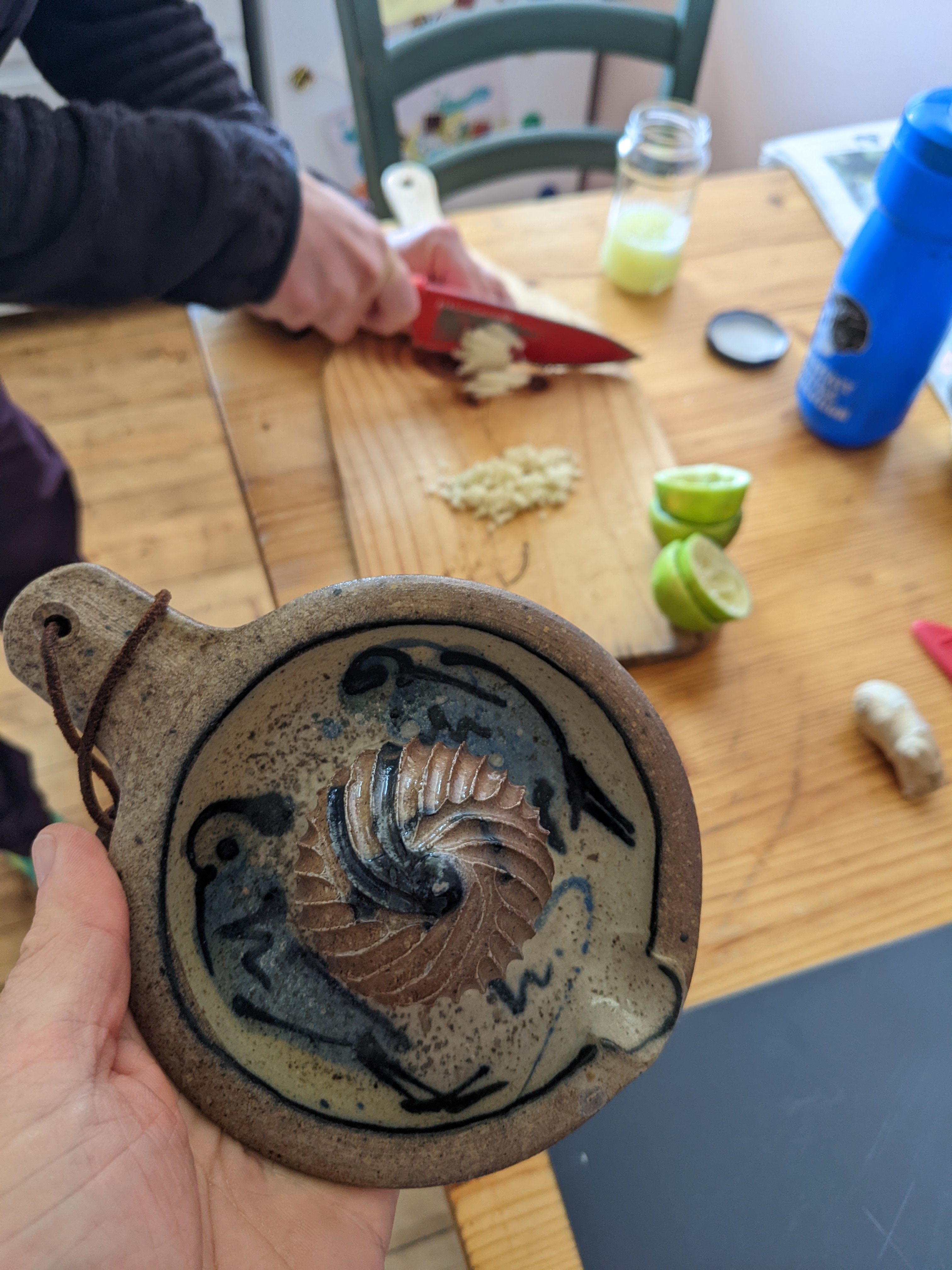 a hand-made ceramic citrus juicer, with limes for the fried rice