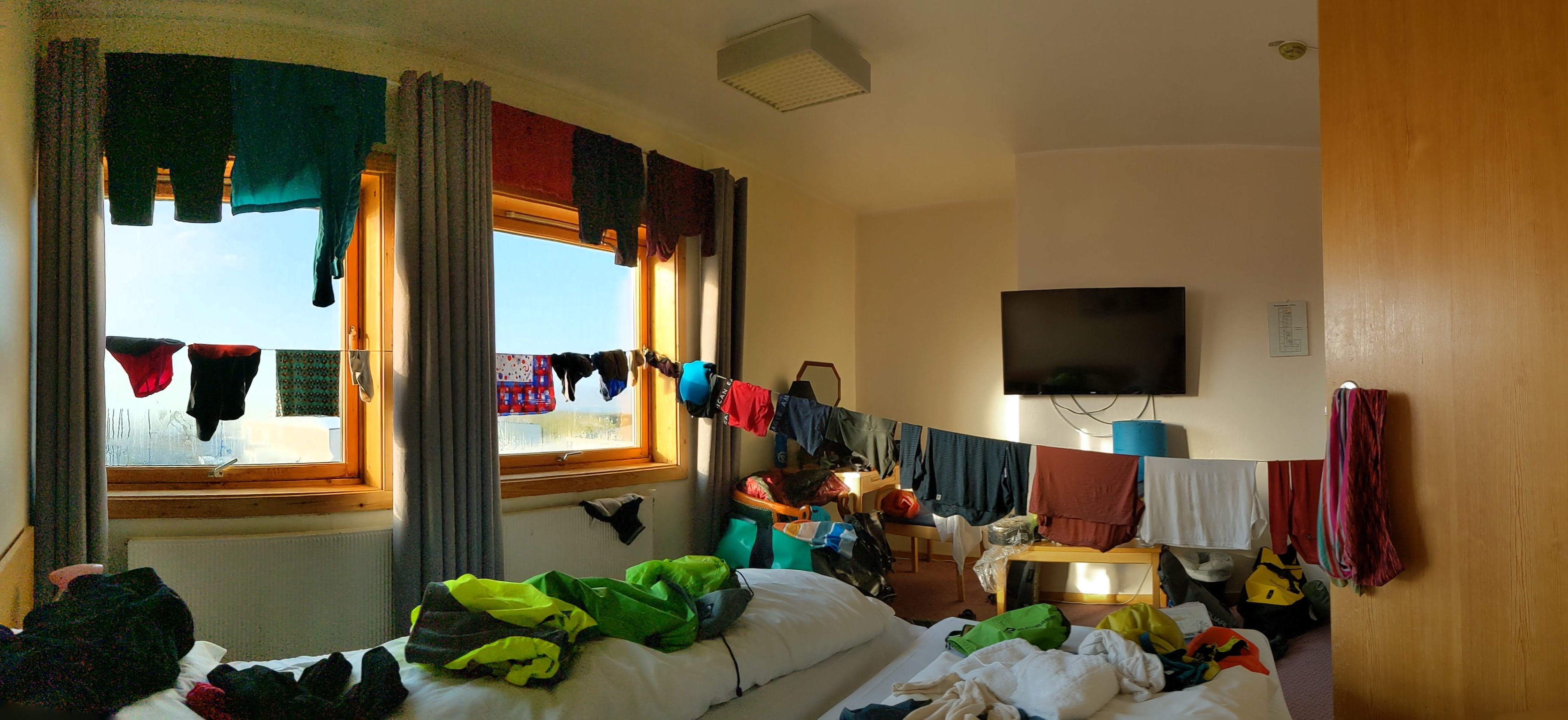 our hotel room in Lakselv with laundry lines covered in wet clothing everywhere