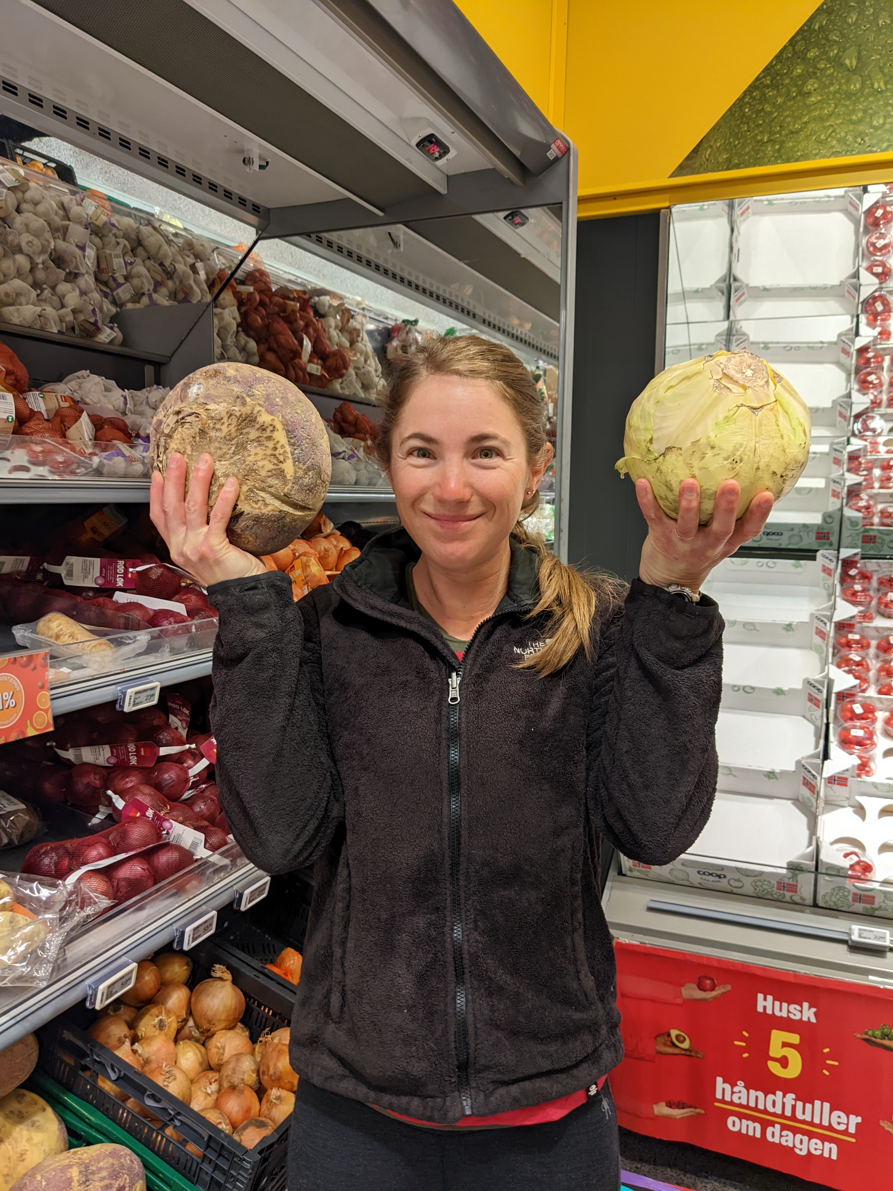 H holding up a beautiful cabbage and an enormous rutabaga