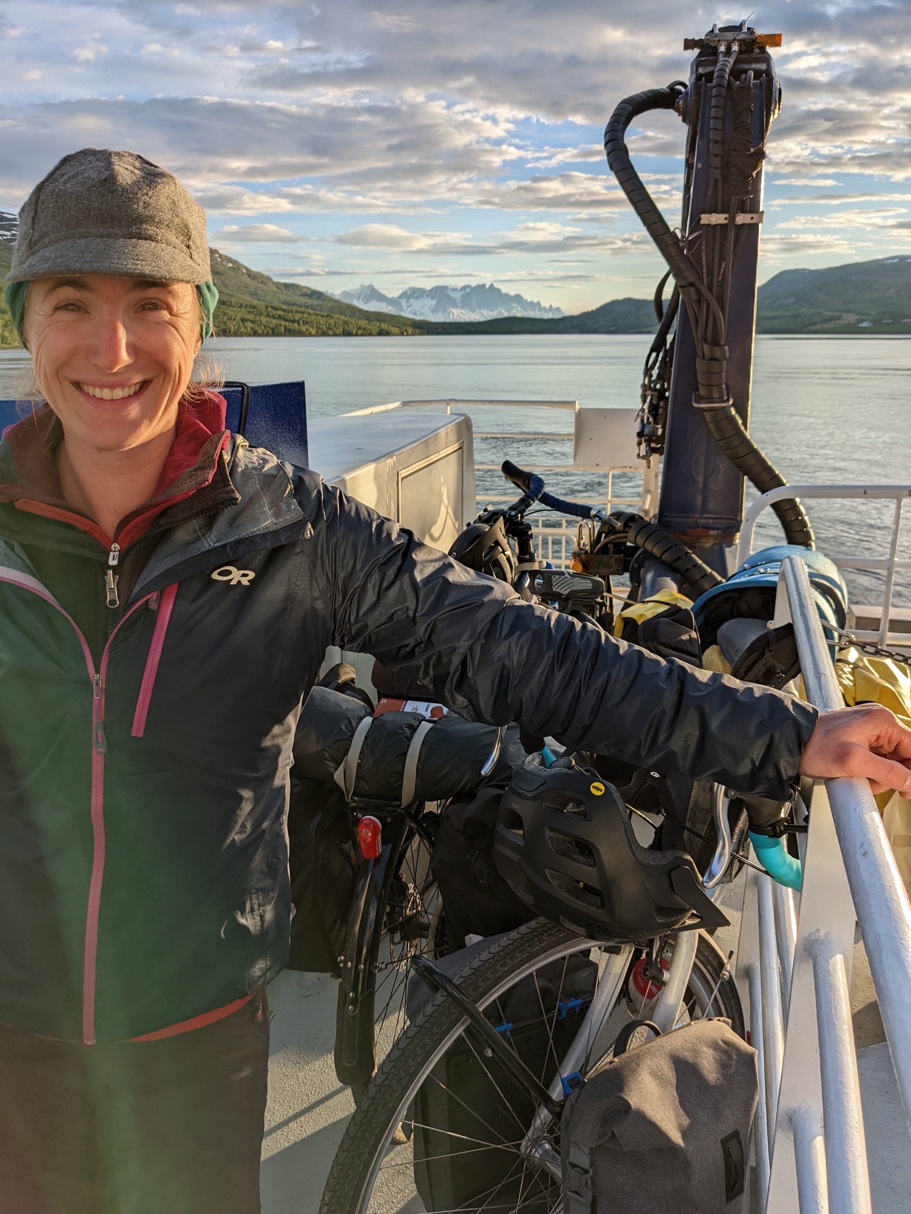 H looking happy but tired on the boat with our bikes