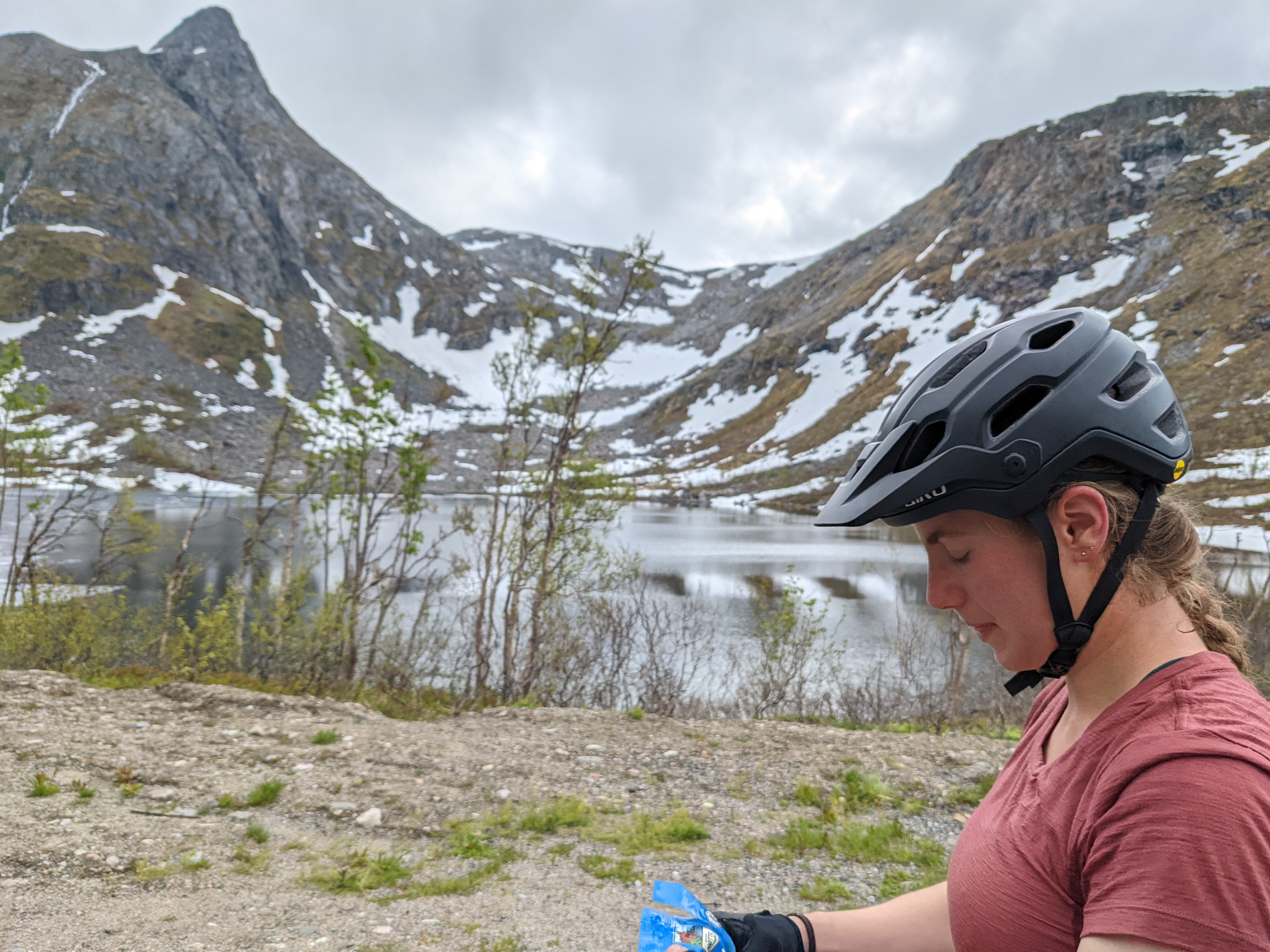 H snacking right in front of an alpine lake and peaks