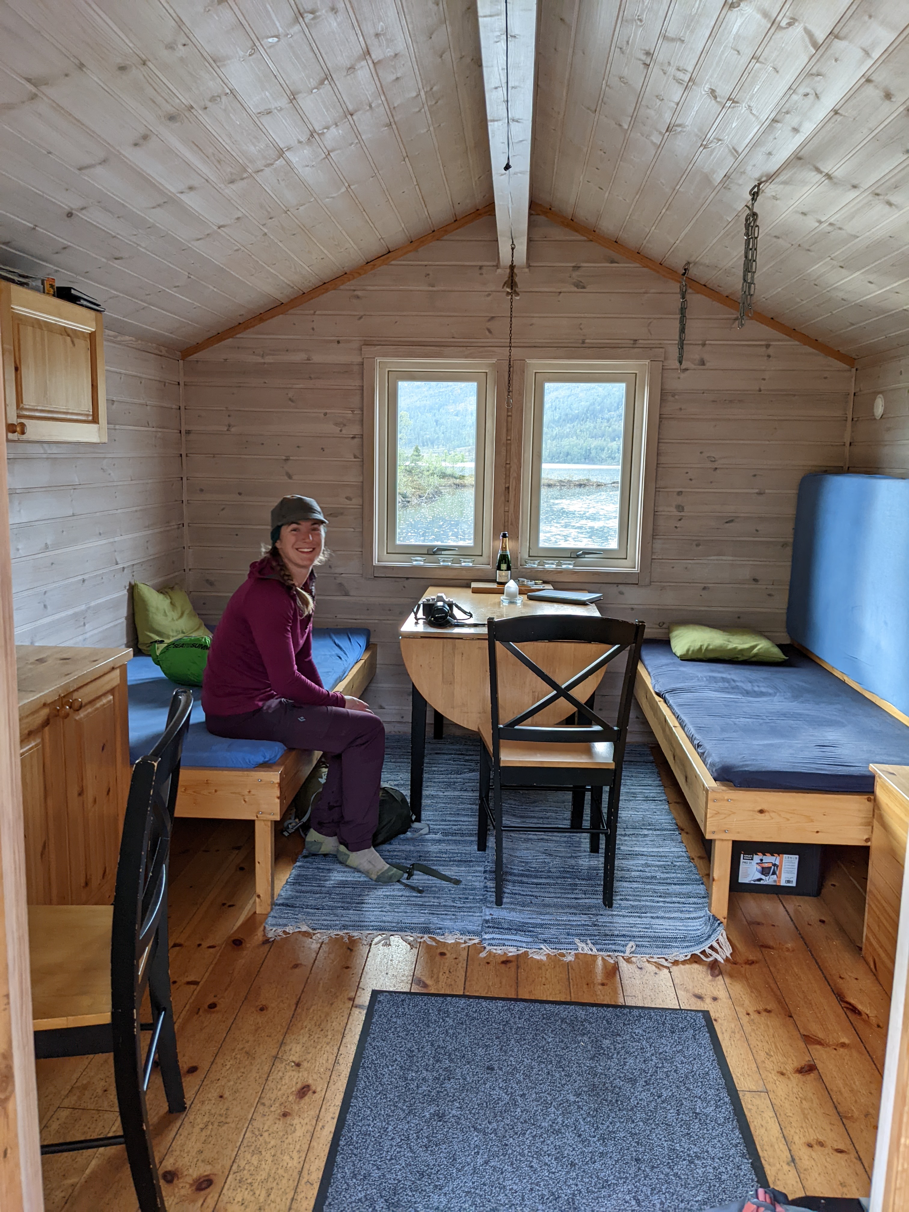 the cabin interior, bright with pine planking and exposed wood walls and roof