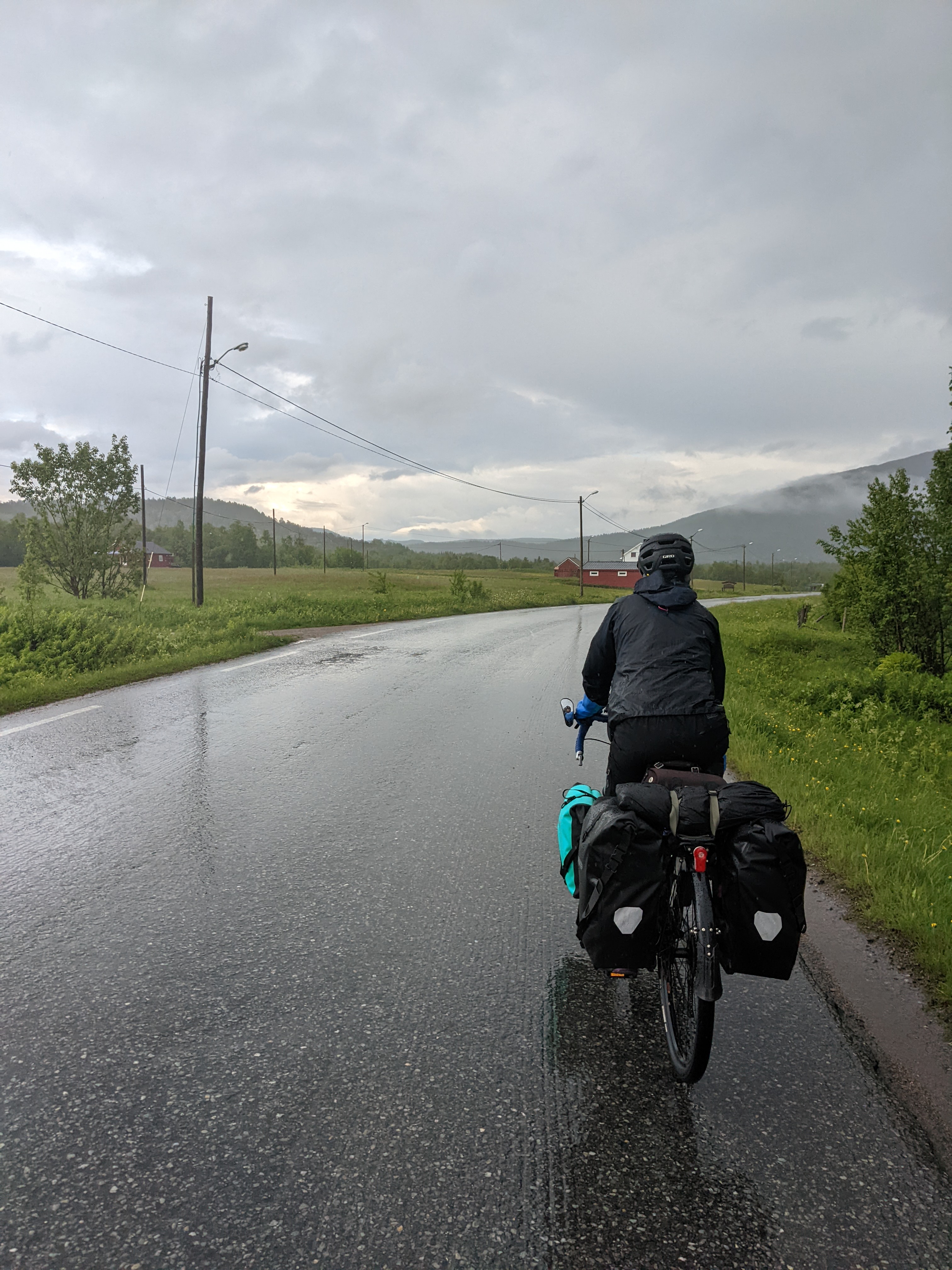 H riding wet road at the end of the rain storm