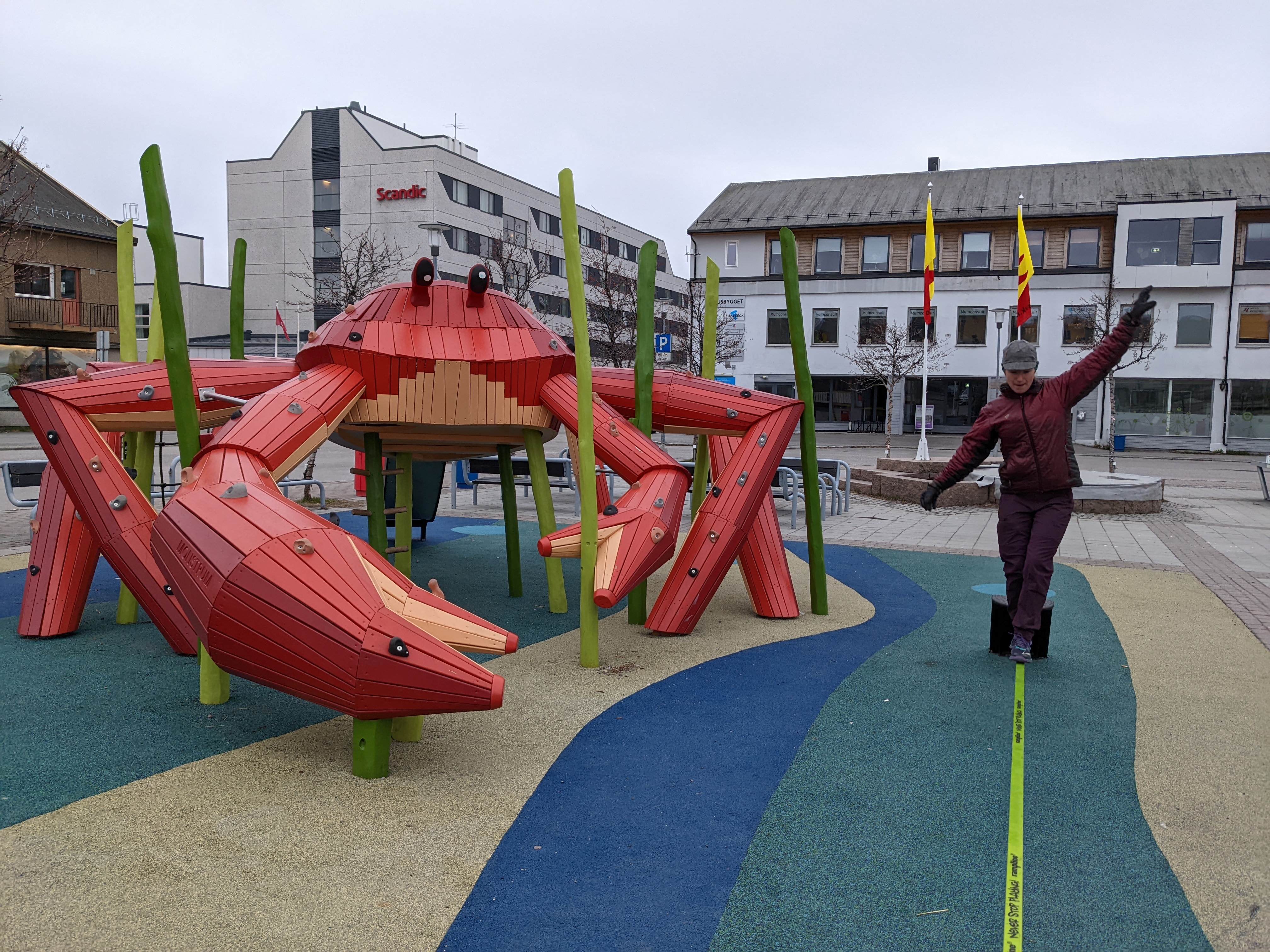 wooden crab playground with trampolines and slack lines