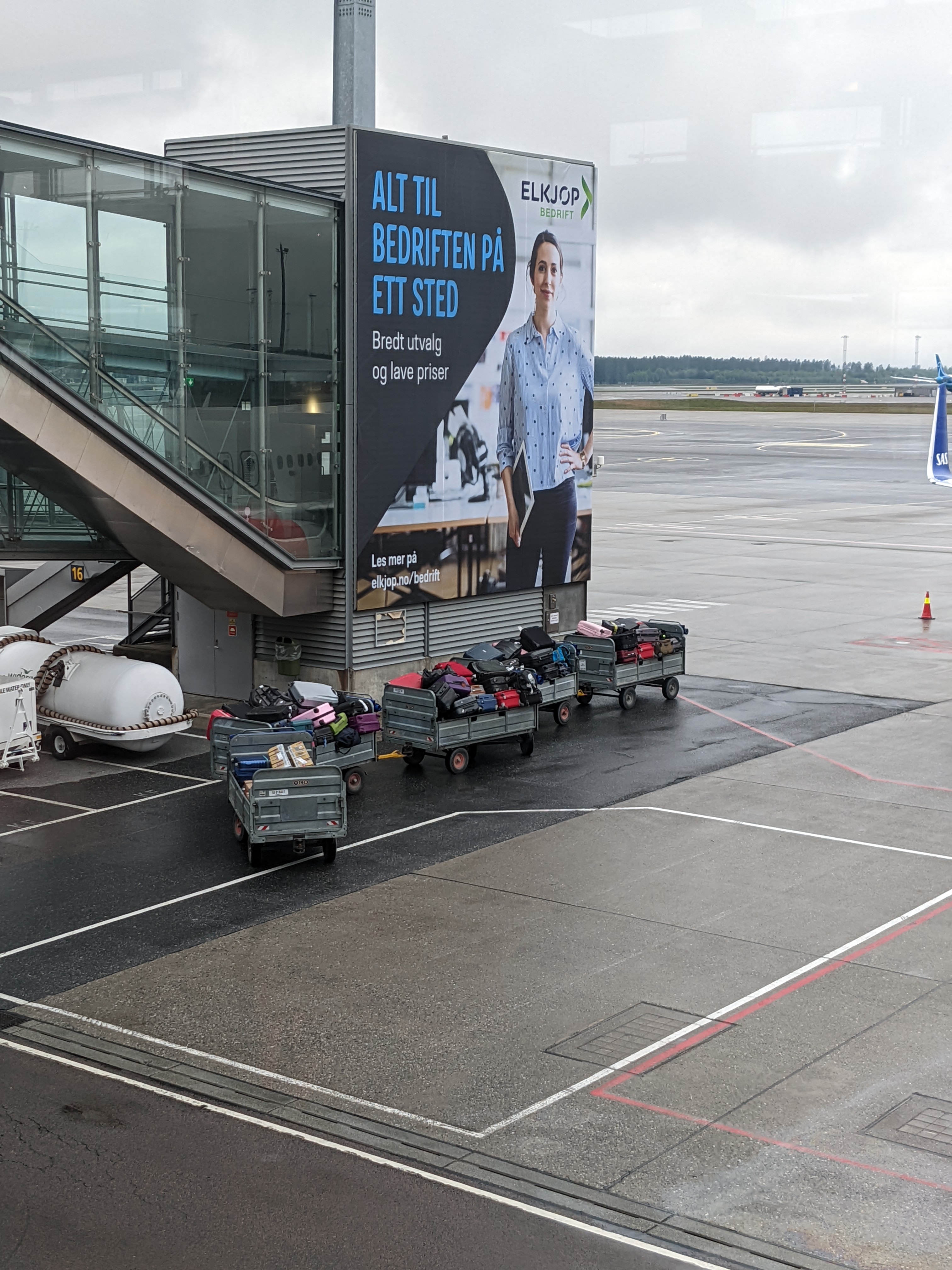 a train of baggage cars bringing our bikes to the plane