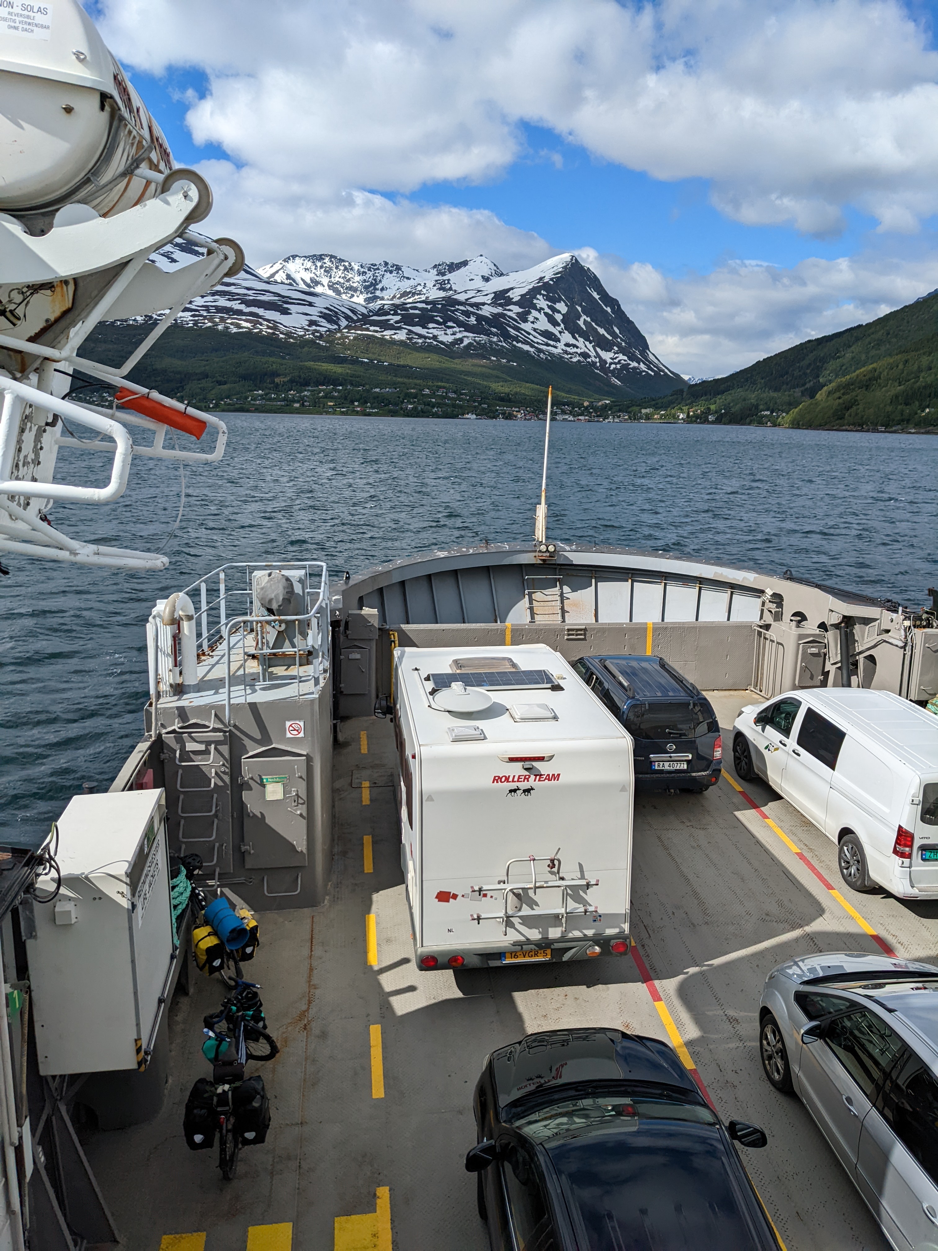 view from ferry of coastal peak, with bicycles on the boat deck below